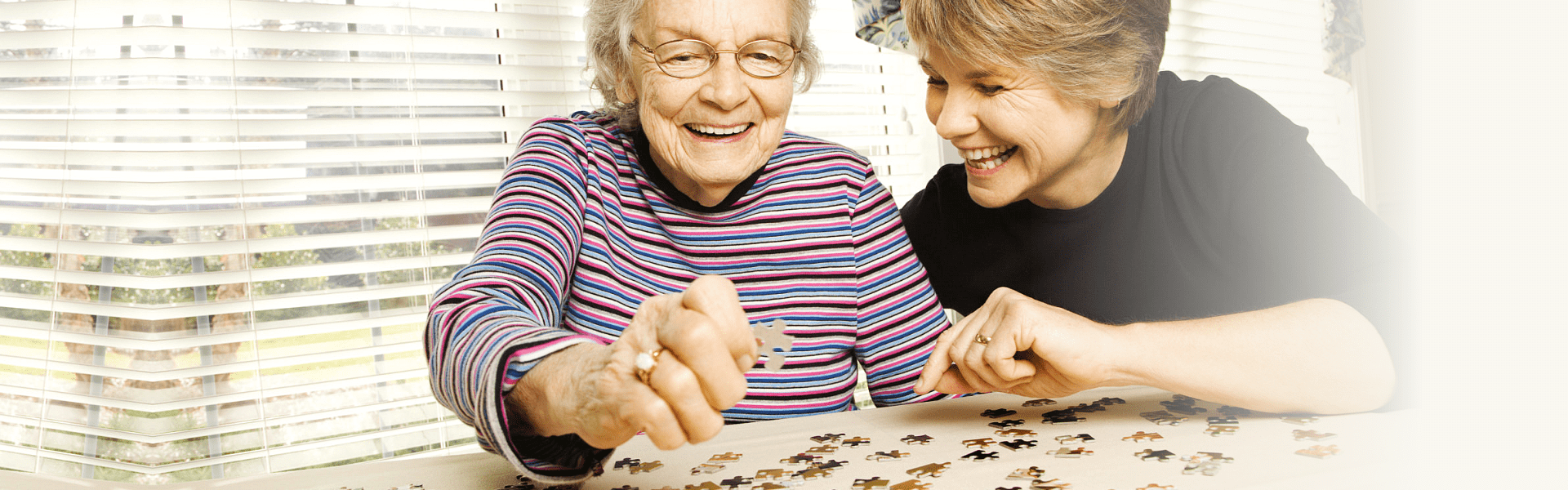 senior woman and caregiver playing